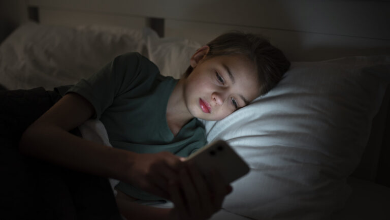 child sleeping with phone scaled e1689239553393 child sleeping with phone